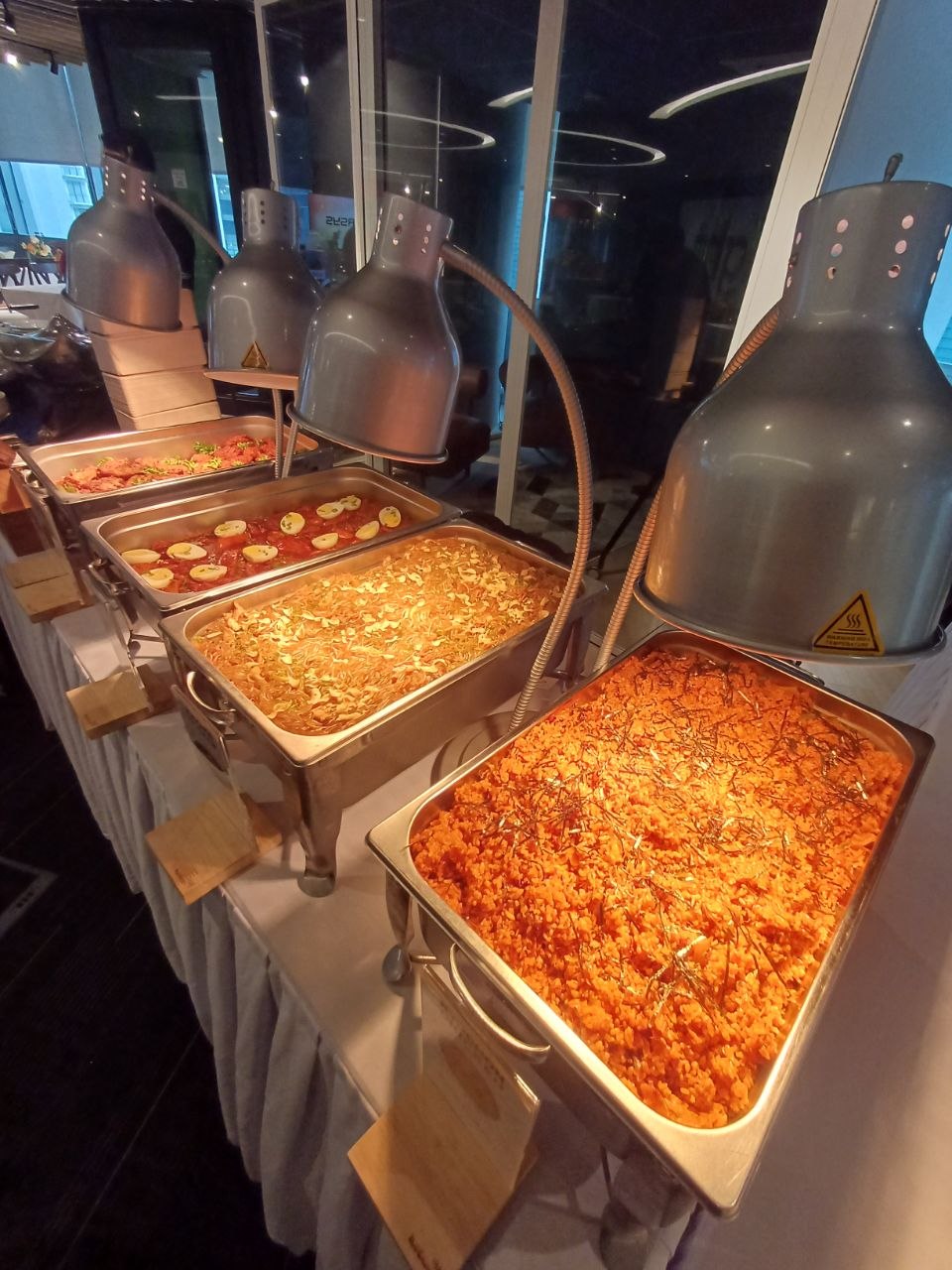 KyoChon Malaysia catering buffet line with kimchi fried rice, japchae noodles and Korean side dishes under heat lamps